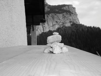 Close-up of toy on rock against wall