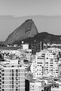 Buildings in congestion with rocky cliff in background