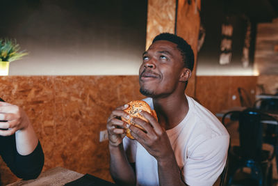 Portrait of young man eating food