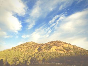 Scenic view of mountains against cloudy sky