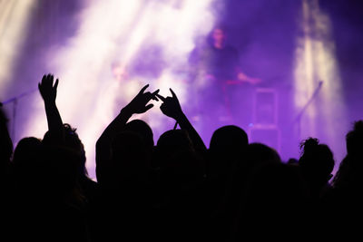 Group of silhouette people at music concert