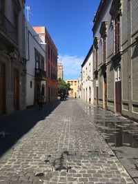 Empty alley amidst buildings in town