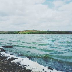 Scenic view of sea against cloudy sky