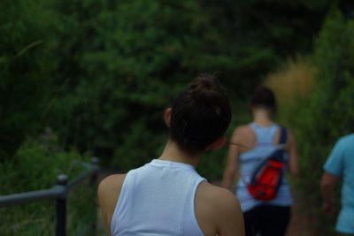 Rear view of woman walking in forest