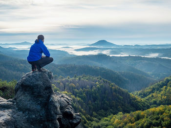 Tourist watching to autumn sun at horizon . beautiful moment miracle of nature. colorful mist