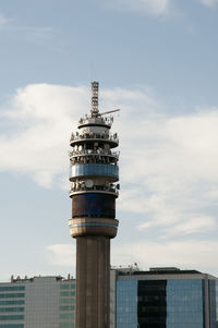 Tower in city against sky