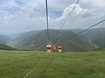 Cable car over grassland 
