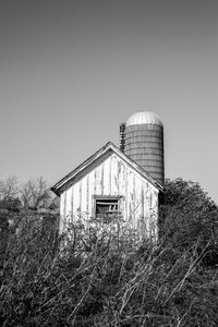 Barn on field against clear sky