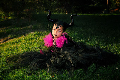 Girl with maleficent costume playing in the woods