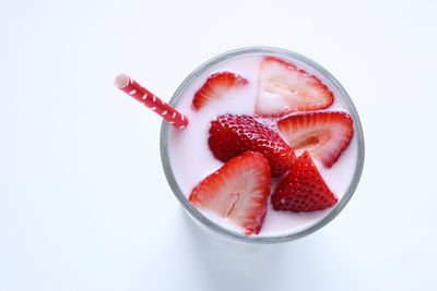 High angle view of strawberries in glass against white background