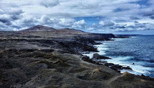 Scenic view of sea against cloudy sky