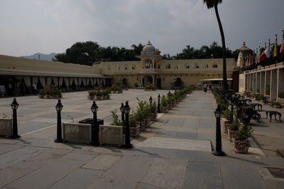 Footpath by historic building against sky