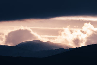 Scenic view of silhouette mountains against sky during sunset