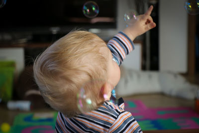 Boy playing with bubbles at home