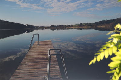 Pier over lake against sky