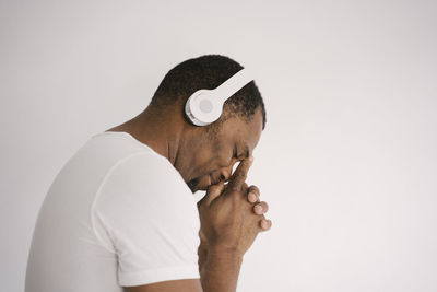 Portrait of young man against white background