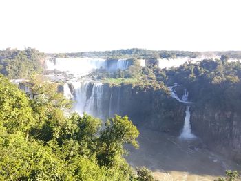 Scenic view of waterfall against sky