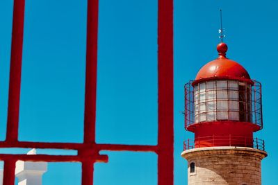 Low angle view of lighthouse against building