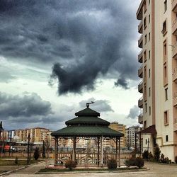 Buildings against cloudy sky