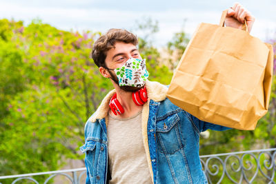 Courier in protective mask and medical gloves delivers takeaway food. delivery service 