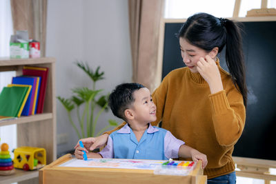 Mother and son on table