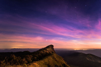 Scenic view of mountains against sky at dusk