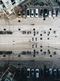 Directly above shot of cars and motorcycles parked on road in city
