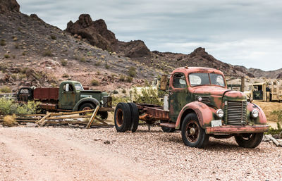 Abandoned truck on field against sky