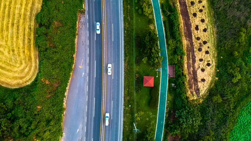 High angle view of cars on road amidst field