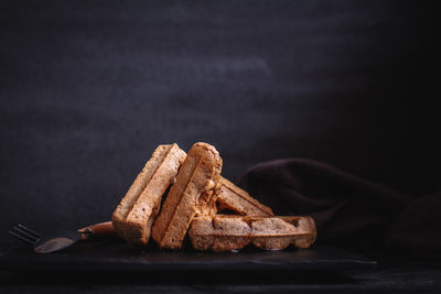 Close-up of chocolate cake against black background