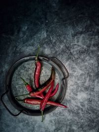 High angle view of red chili pepper over white background