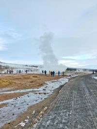 People on beach against sky