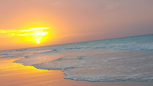 Scenic view of sea against romantic sky at sunset