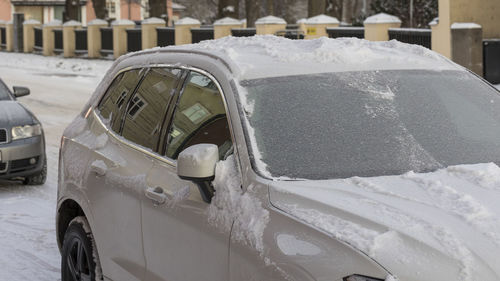 The cars are covered with ice and snow