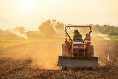 View of tractor on field against sky