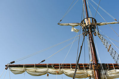 Low angle view of sailboat against clear sky