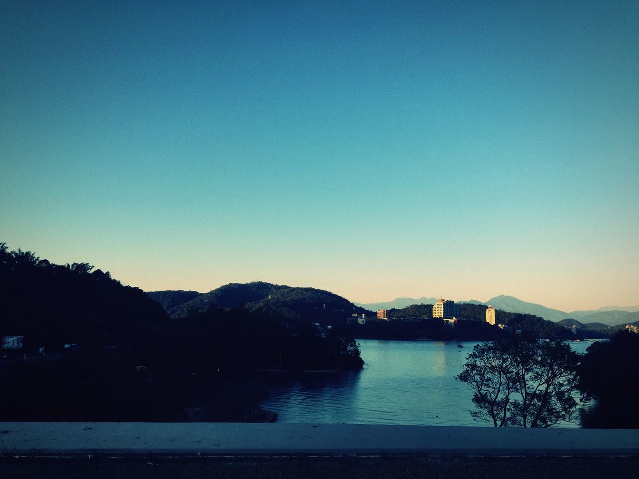 SCENIC VIEW OF RIVER BY MOUNTAIN AGAINST CLEAR BLUE SKY