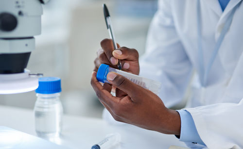 Midsection of doctor examining patient in clinic