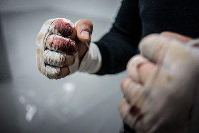 Midsection of boxer with bandages in fighting stance