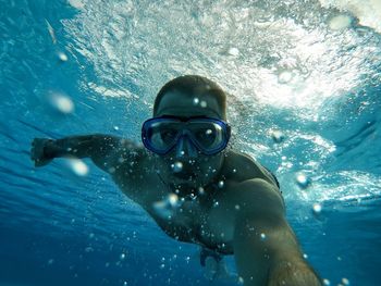 Portrait of man swimming in sea