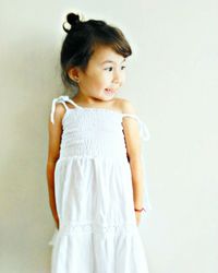 Portrait of girl standing against white background