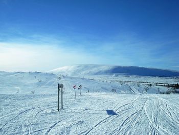 Scenic view of snow covered mountains against sky