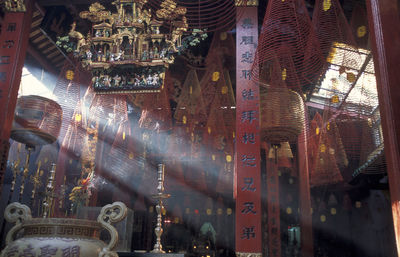 Low angle view of spiral incense sticks hanging in temple