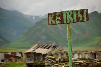 Information sign on landscape against sky