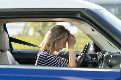 Portrait of woman sitting in car