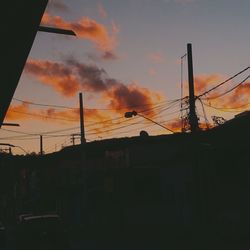 Silhouette buildings against sky during sunset