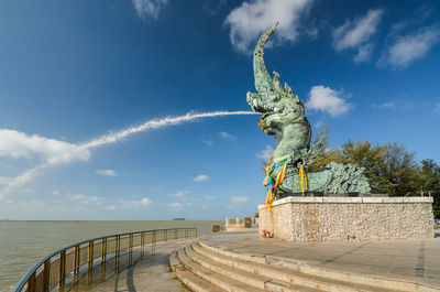 Serpent head fountain against sky