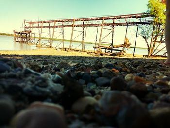 Surface level of pebble on beach against sky