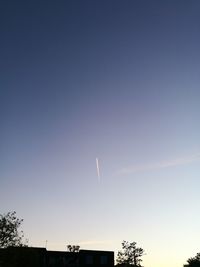 Low angle view of silhouette trees against clear sky