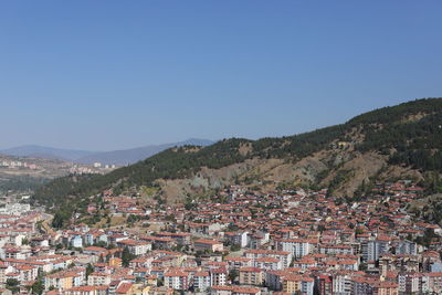 Townscape against clear blue sky